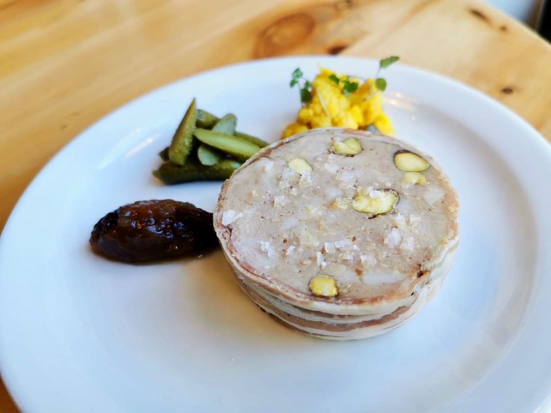 Pheasant, partridge and pork terrine wrapped in smoked pancetta and served with apple chutney, gherkins and piccalilli. Packed with flavours and textures. On now at Chapel Row.